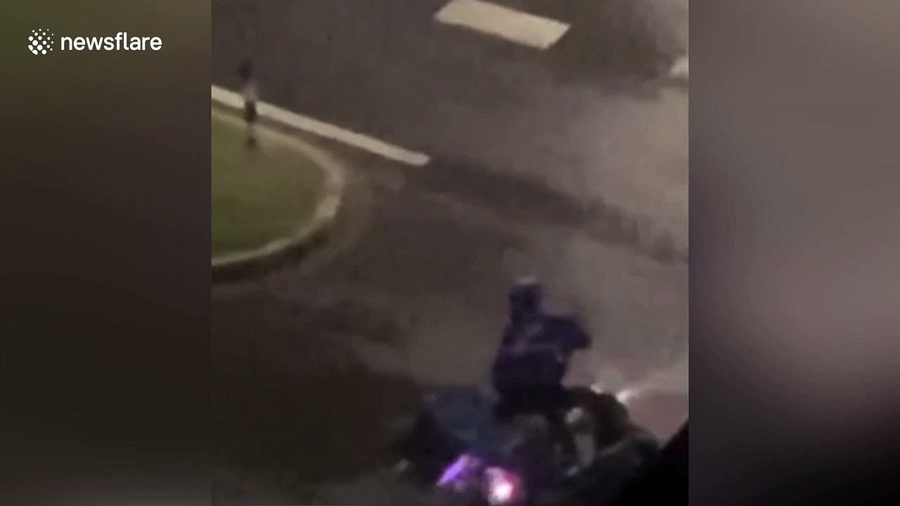 Chinese delivery man clings onto bollard to avoid being blown away by powerful winds during typhoon Hagupit