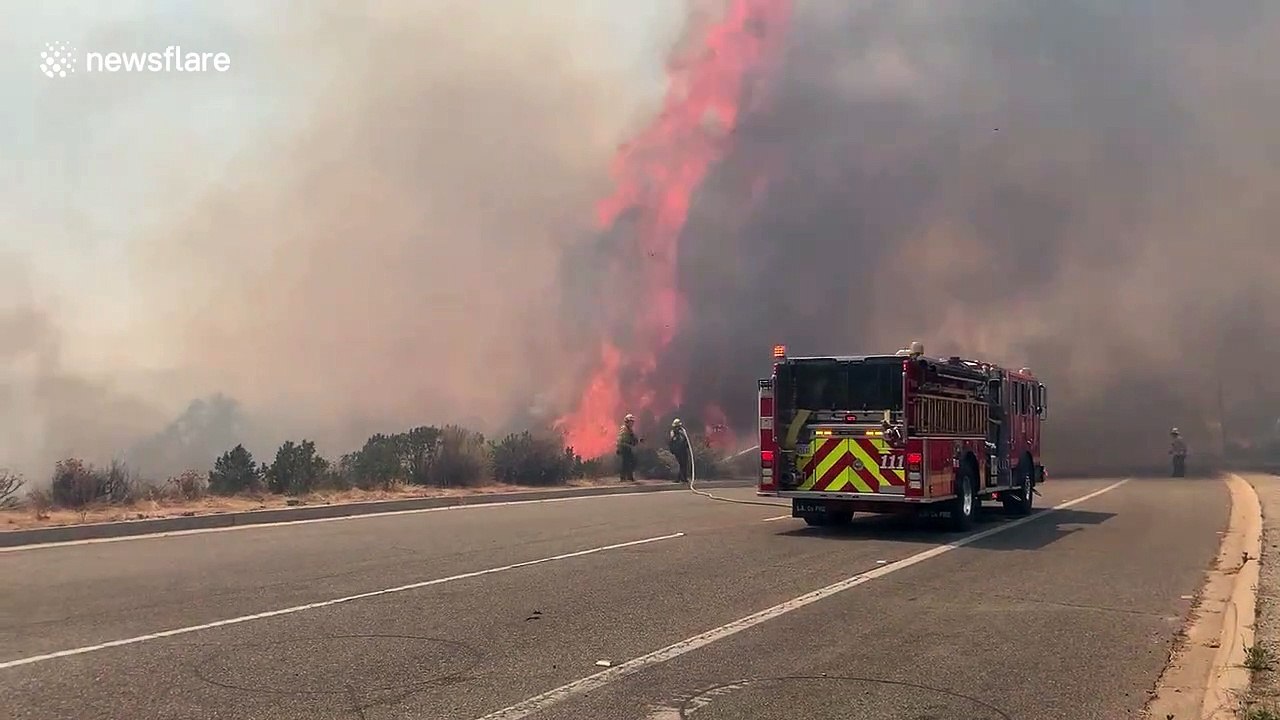 Violent flames come metres from fire truck battling brush fire in California