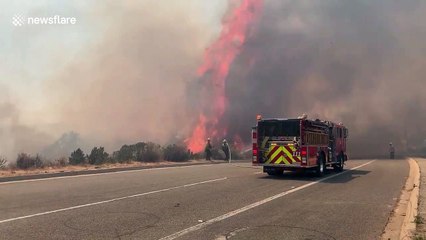 Violent flames come metres from fire truck battling brush fire in California