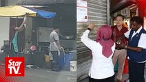 Worker caught in fish smashing act in back alley of Kota Kemuning restaurant