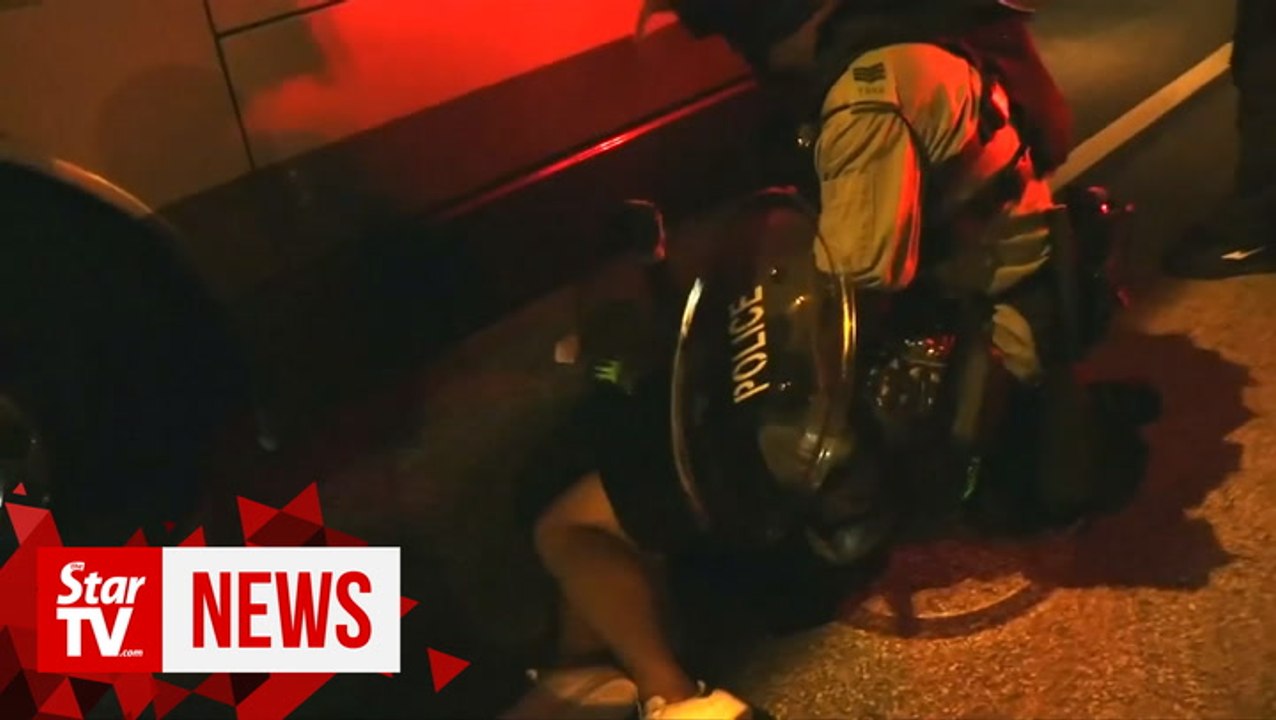 HK police fire tear gas to counter brick-throwing protesters