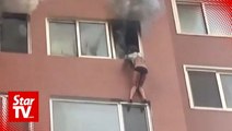 Woman trapped hanging outside 8th floor window in house fire