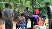 Thai villagers go fishing in swollen river after storm Sinlaku heavy rain