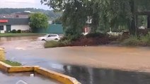 Car stranded in flooded parking lot