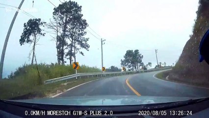 Motorcycle rider crashes and skids towards oncoming car while frantically trying to avoid being hit