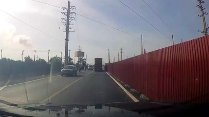 Container truck falls over while taking tight corner in Vietnam