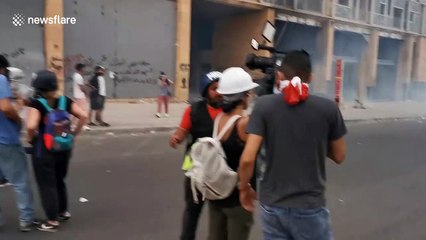Dramatic footage of protesters escaping tear gas as Lebanon's prime minister resigns
