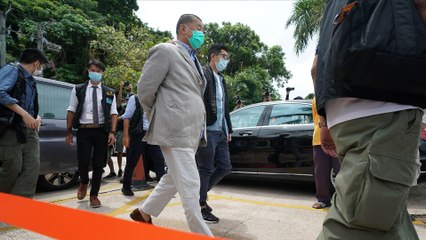 Police escort Apple Daily founder Jimmy Lai to his yacht after his arrest on security law charges