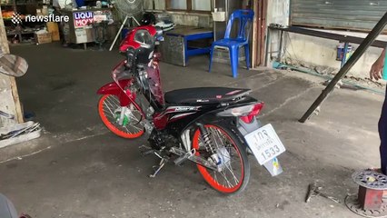 Schoolboy rides pillion with his own broken-down scooter on his lap