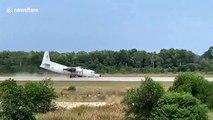 Military plane crash lands by skidding along nose after front wheel fails