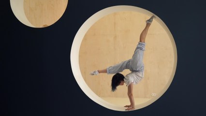 Girl Shows Flexible Moves While Doing Handstand Balance in Circular Structure