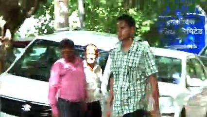 This Ear cleaner causes his client to grimace with both relief and pain!