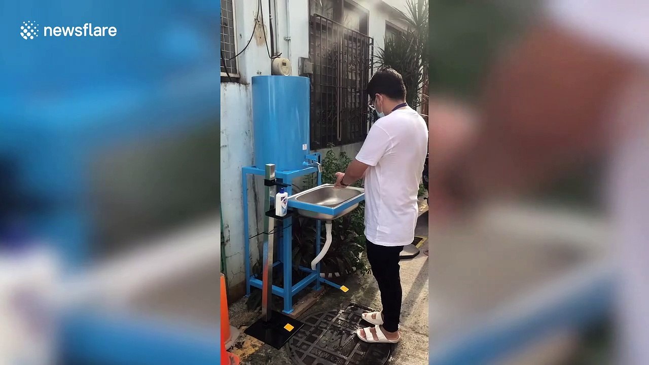 Residents in the Philippines install mandatory COVID-19 wash basins on their street