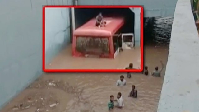 Gujarat: Bus rescued after stuck under a waterlogged bridge