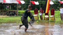 Traditional Indonesian martial art sees two competitors battle in muddy rice field