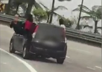 'Stunt' women perched on car windows to face the music