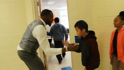 Teacher wins hearts with personalised handshakes
