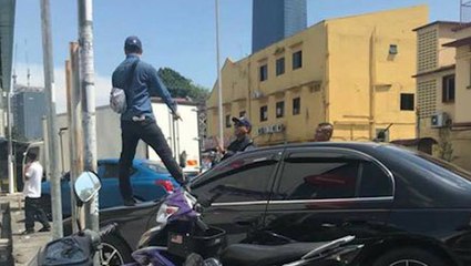 Unhappy with DBKL's car clamping, man protests on car