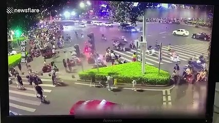 Two people land on car roof after their electric bike strikes oncoming vehicle in China