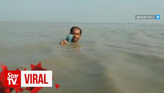 Pakistani reporter in neck-deep floodwaters goes viral