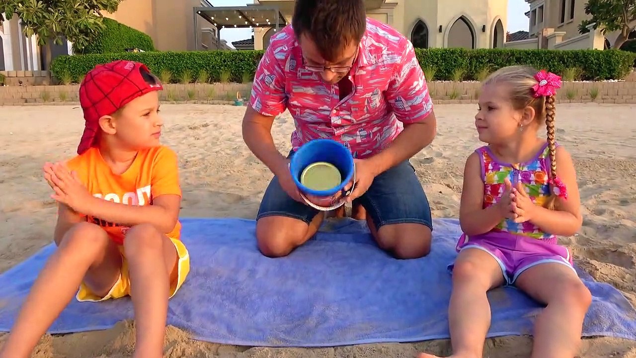 Diana and Roma play on the Beach with Dad