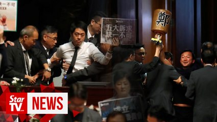 HK lawmakers dragged from chamber as leader heckled for second day