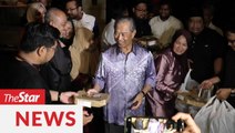 New PM gives pizza to waiting media