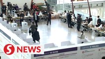 South Korea kicks off voting in masks and gloves