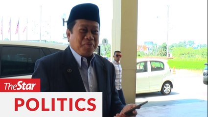 Ahmad Maslan reads out a poem for the media on political uncertainty