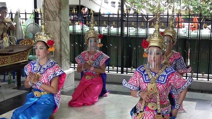 Thai dancers wear Covid-19 face shields at Buddhist shrine