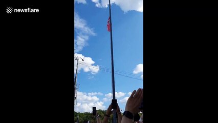 Cheers ring out as protesters fly opposition flag at full mast in Belarus