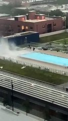Pool Workers Scramble to Tie down Furniture during Intense Winds