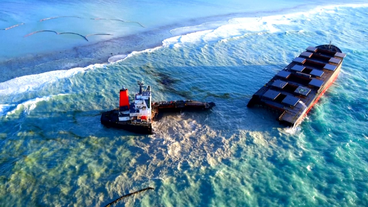 Tugboats pull Japanese cargo ship to open sea after it broke up and leaked fuel off Mauritius