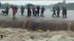 Boys perform dangerous stunt in flood water