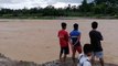 Teachers stranded by flooded river after heavy rain in the Philippines
