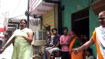 Hijra dances on a street in Delhi, places money into her blouse - Indian transvestites