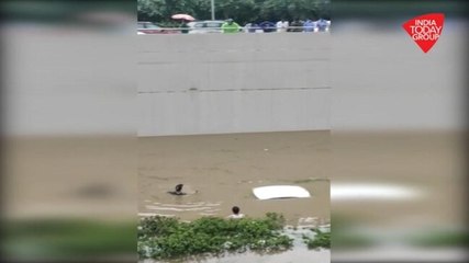 Commuters swim in Gurugram canal after heavy rain submerges their car