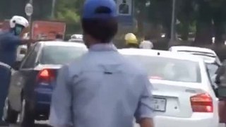 Pakistan traffic police officer is picking flage in the middle of road and kissing the flage must be appreciated