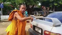 Buddhist monk accidentally drives with rescued pet dog tied to car