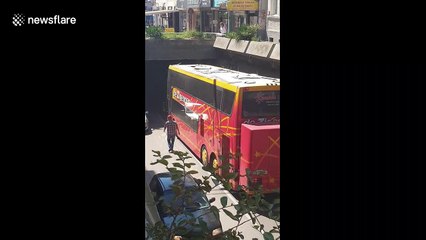 Double-decker coach carrying students smashes into underpass in Bulgaria and gets stuck