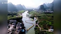 Dozens of bamboo rafts form 800-metre-long dragon on river to celebrate Chinese Valentine's Day