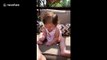Excitable baby can't stop laughing at the size of her aunt's foot