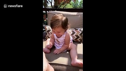 Excitable baby can't stop laughing at the size of her aunt's foot