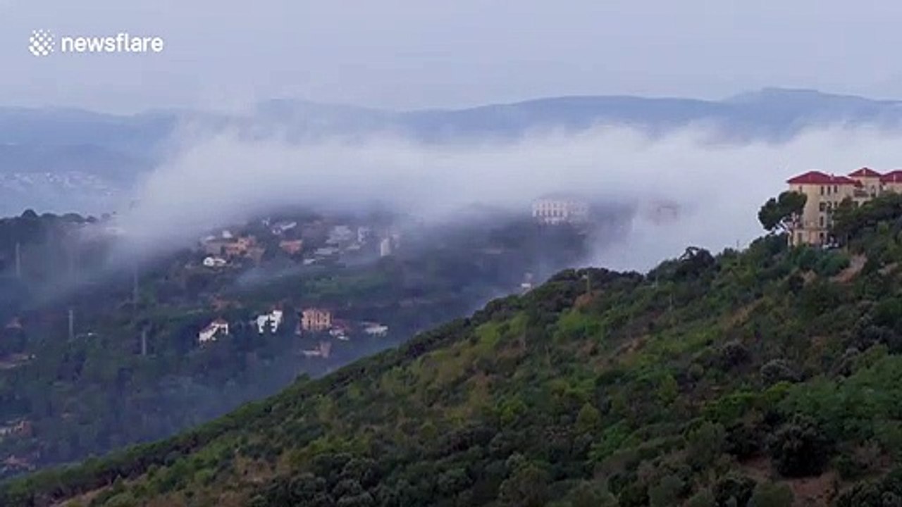 Watch as cool fog cascades down from the mountains and covers Barcelona before evaporating in the city warmth