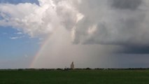 Sky With Rainbow on One Side and Dark Storm Clouds on Other Side in Saskatchewan