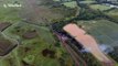 Drone captures cloud of smoke rising from derailed diesel train in Wales, UK