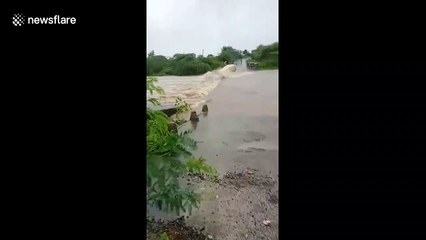 Terrifying moment truck swept into fast-flowing river during heavy floods in India