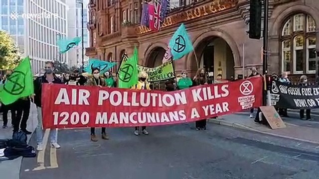 Extinction Rebellion block streets in centre of Manchester, UK