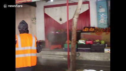 Palestinian workers spray disinfectant on roads and buildings as Gaza lockdown continues