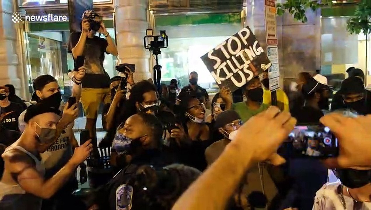 Senator Rand Paul surrounded by protesters and is escorted by police in Washington